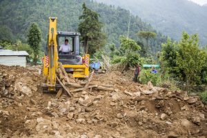 Gary Young on the backhoe clearing debris in Nepal